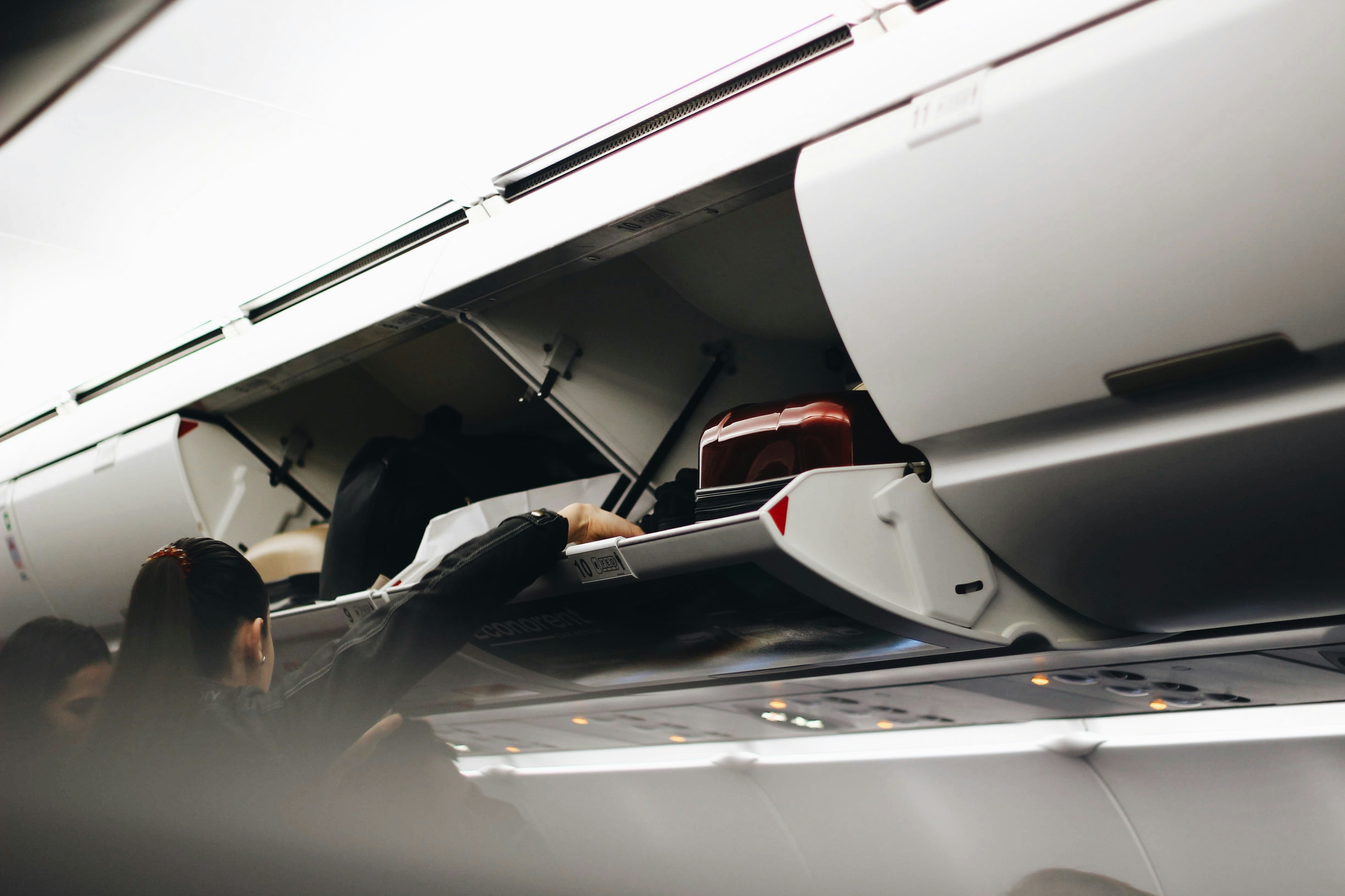 What Should You Do If a Plane Passenger Puts a Suitcase in Your Overhead Bin? Here’s What Flight Attendants Say