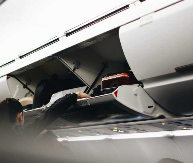 What Should You Do If a Plane Passenger Puts a Suitcase in Your Overhead Bin? Here’s What Flight Attendants Say