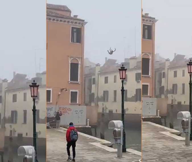 Moment person jumps off three-story building into Venice canal